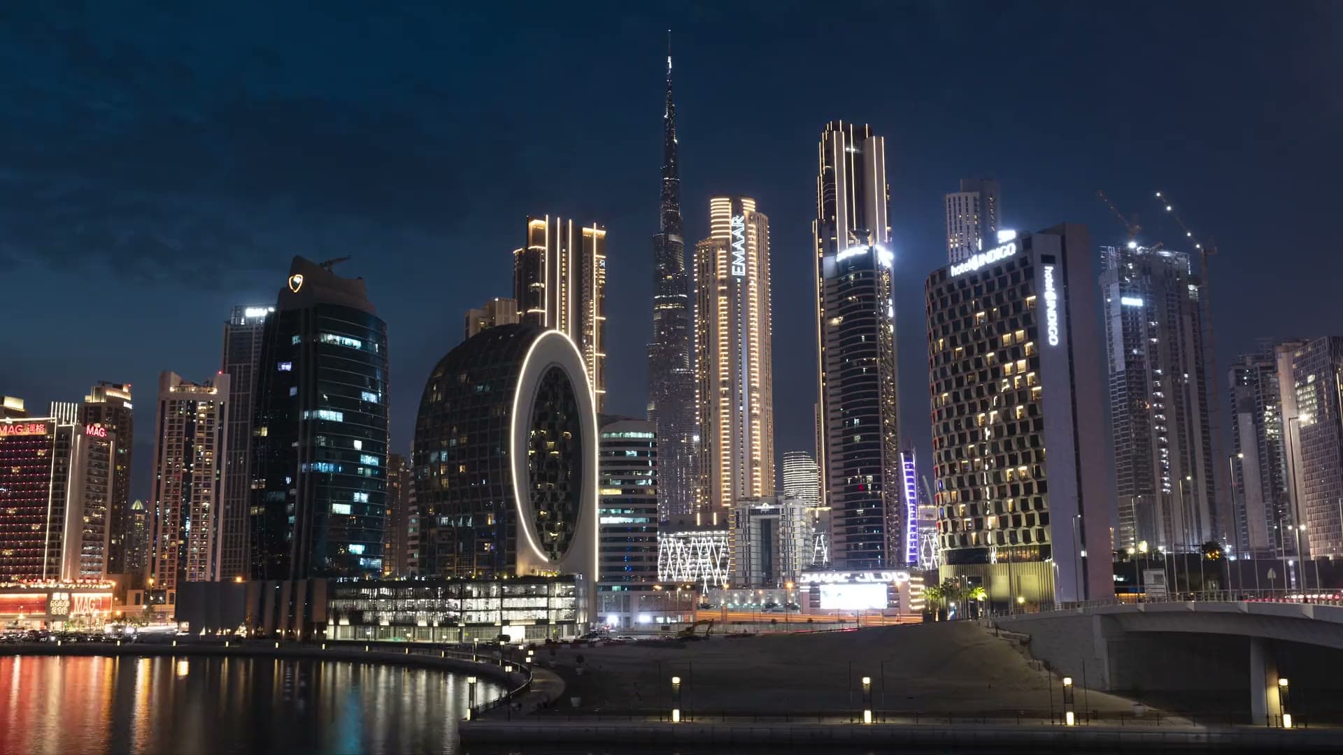 Downtown Dubai and the Burj Khalifa at nightfall, seen across the water